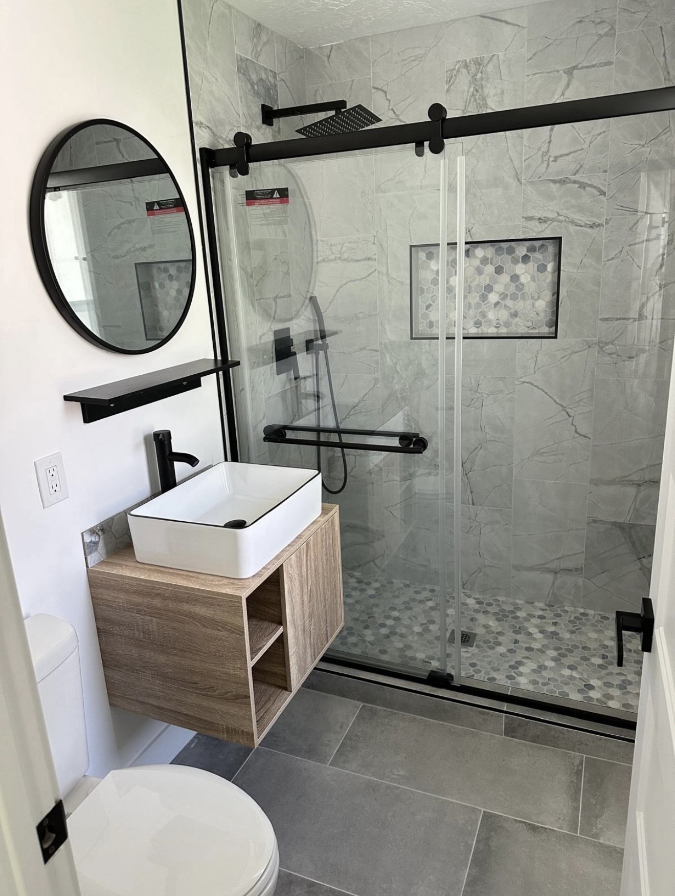 Compact bathroom with glass shower and vessel sink
