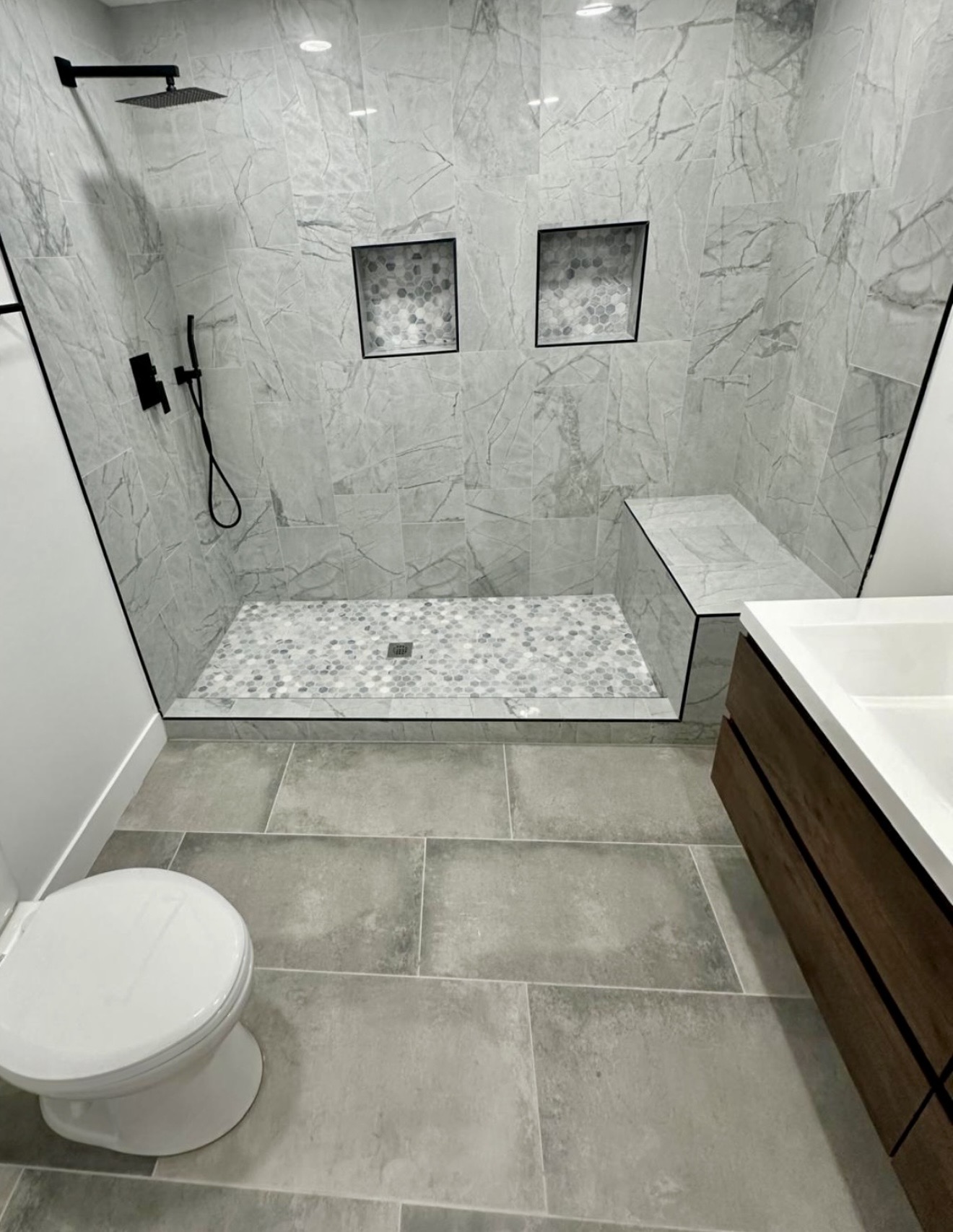 Modern gray bathroom with glass walk-in shower
