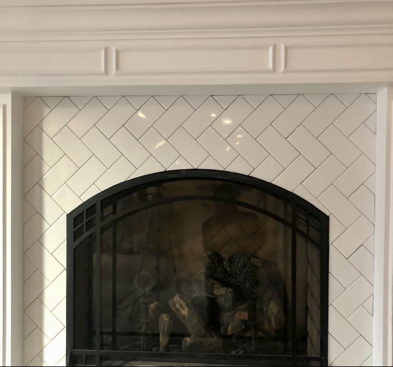 White herringbone tiled fireplace